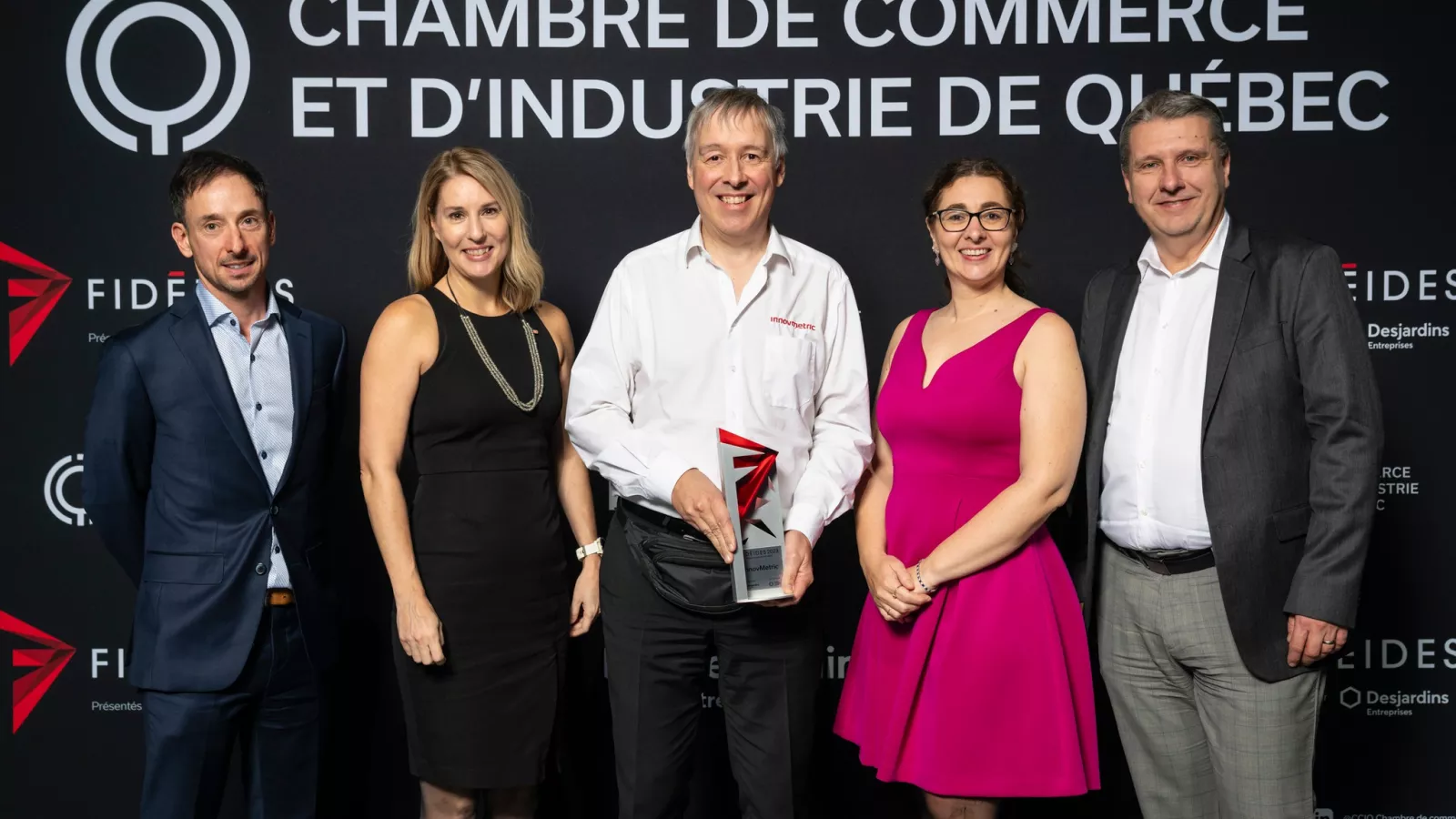 The delegation from InnovMetric on stage, proudly receiving a third and unexpected prize, "Prix Rayonnement Hors Québec"! 